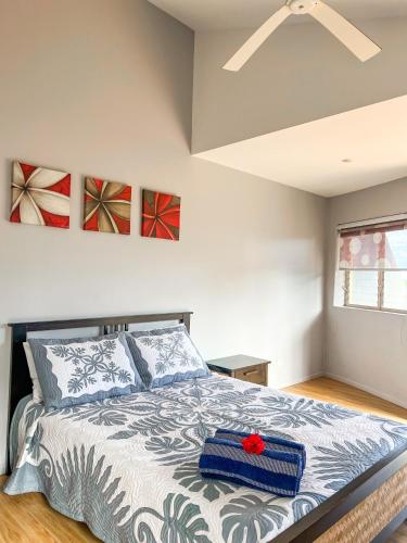 a bedroom with a bed with a red flower on it at Iro Luxury Retreat in Rarotonga