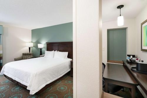 a hotel room with a bed and a desk at Hampton Inn & Suites Mooresville in Mooresville