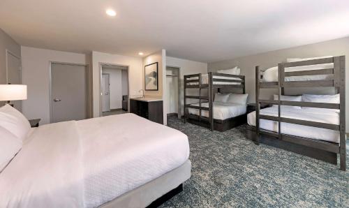 a bedroom with two beds and two bunk beds at Seacliff Inn Aptos, Tapestry Collection by Hilton in Aptos