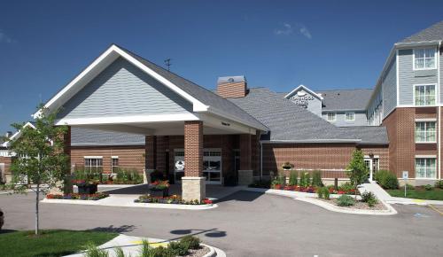 a large brick building with a parking lot at Homewood Suites by Hilton Madison West in Madison