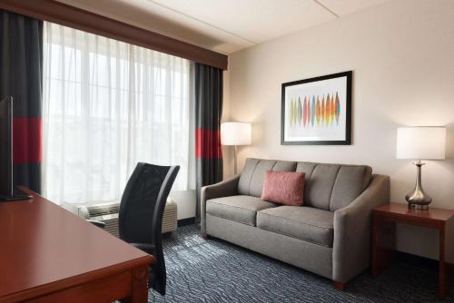 a living room with a couch in a hotel room at Homewood Suites by Hilton Madison West in Madison