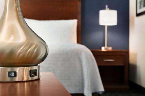 a lamp sitting on a table next to a bed at Homewood Suites by Hilton Madison West in Madison