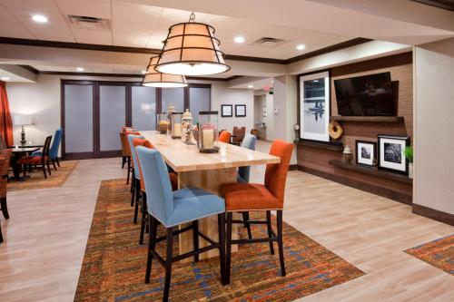a dining room with a long table and chairs at Hampton Inn Minneapolis Bloomington West in Bloomington
