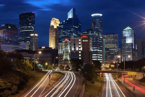 a city skyline at night with traffic on a highway at Hilton Garden Inn Minneapolis Downtown in Minneapolis