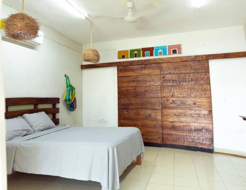 a bedroom with a bed and a wooden wall at Casa don Conde/equipado/wifi/bicicletas gratis. in Valladolid