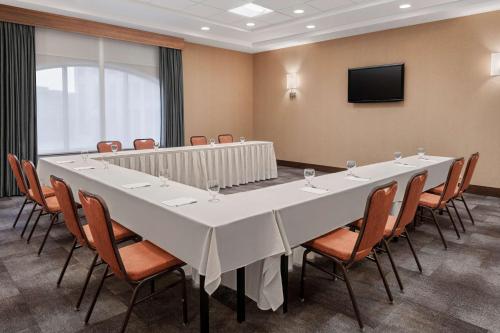 a large conference room with a large white table and chairs at Hilton Garden Inn Minneapolis Downtown in Minneapolis