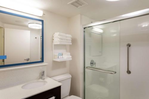 a bathroom with a shower and a toilet and a sink at Hampton Inn Minneapolis/Eagan in Eagan