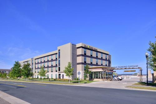 an empty street in front of a large building at Home2 Suites By Hilton Eagan Minneapolis in Eagan