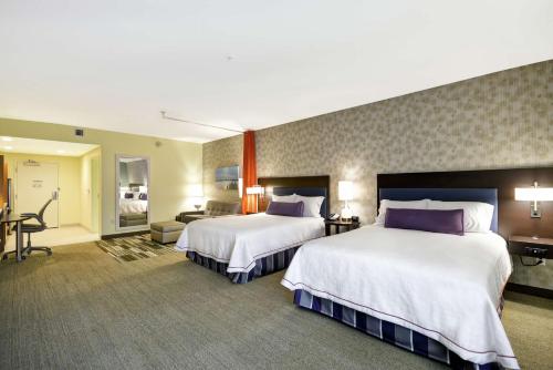 a hotel room with two beds and a desk at Home2 Suites By Hilton Minneapolis-Eden Prairie in Minnetonka
