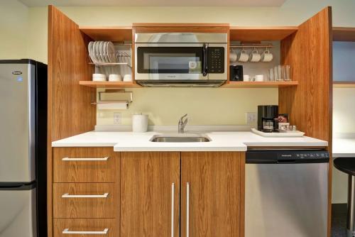 a kitchen with a sink and a microwave at Home2 Suites By Hilton Minneapolis-Eden Prairie in Minnetonka
