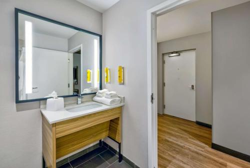 a bathroom with a sink and a mirror at Tru By Hilton Minneapolis, Mn in Minneapolis