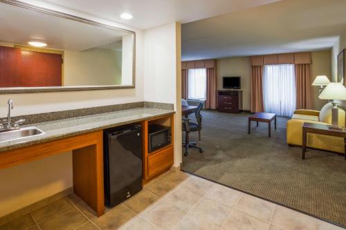 a hotel room with a kitchen and a living room at Hampton Inn & Suites Lino Lakes in Lino Lakes