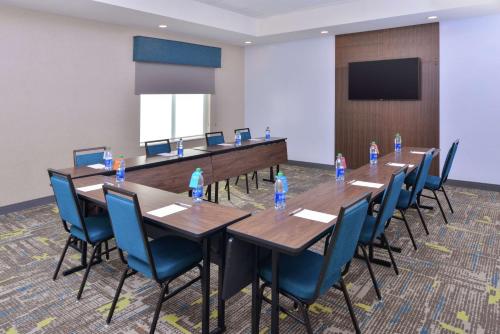 a conference room with tables and chairs with bottles of water at Hampton Inn Lakeville Minneapolis, Mn in Lakeville