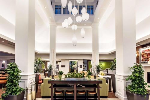 a lobby of a hotel with a table and chairs at Hilton Garden Inn Minneapolis Airport Mall of America in Bloomington