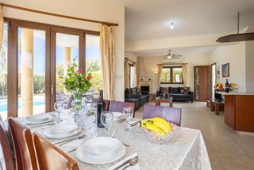a dining room with a table with bananas on it at Villa Tsikkos Ena in Argaka