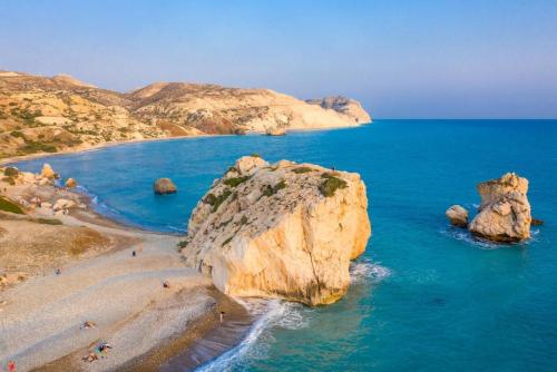 a group of people on a beach with rocks in the water at Villa Tsikkos Ena in Argaka