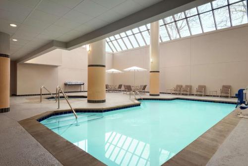 a swimming pool in a large room with a building at DoubleTree by Hilton St. Paul, MN in Saint Paul