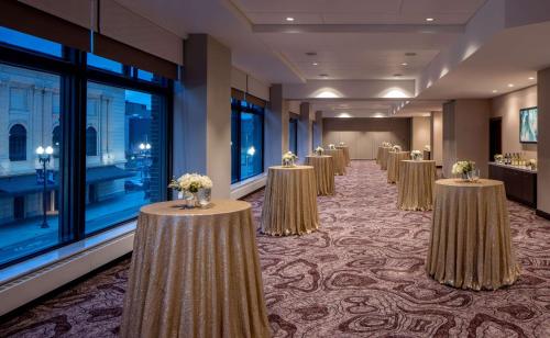 a row of tables in a room with windows at Embassy Suites By Hilton Minneapolis Downtown Hotel in Minneapolis