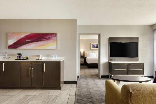 a hotel room with a couch and a television at DoubleTree by Hilton St. Paul, MN in Saint Paul