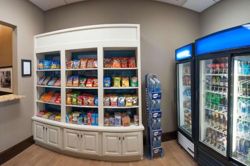 a store aisle with a refrigerator and food at Hampton Inn & Suites New Orleans/Elmwood in Harahan