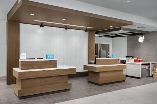 a lobby of a store with wooden counters at Hilton Garden Inn Florence Cincinnati Airport South in Florence