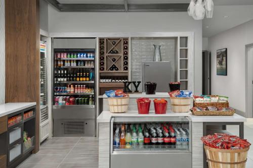 a drink station in a store with a lot of drinks at Hilton Garden Inn Florence Cincinnati Airport South in Florence