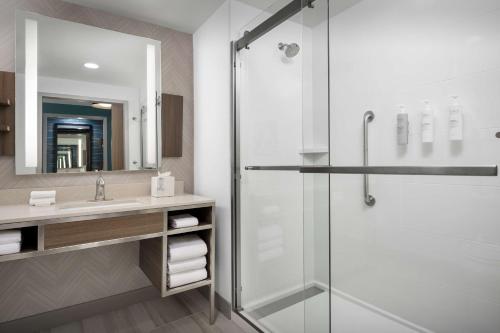 a bathroom with a shower and a sink at Hilton Garden Inn Florence Cincinnati Airport South in Florence
