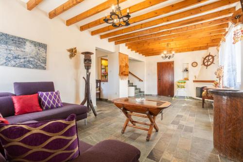 a living room with a wooden ceiling at Villa Petroktisto in Pomos