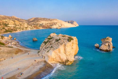 a group of people on a beach with rocks in the water at Villa Petroktisto in Pomos
