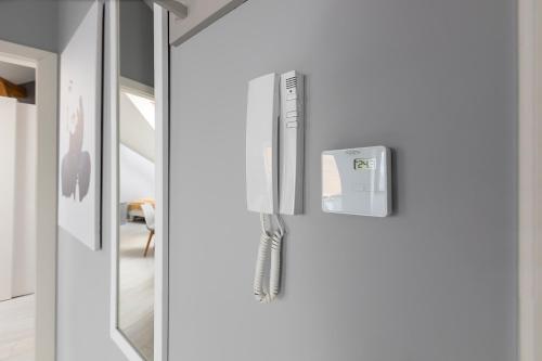 een witte koelkast met een wii controller erop bij Living Apartments Poznań in Poznań