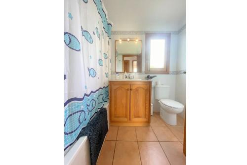 a bathroom with a tub and a sink and a toilet at Villa Mar Uno in Cala'n Bosch