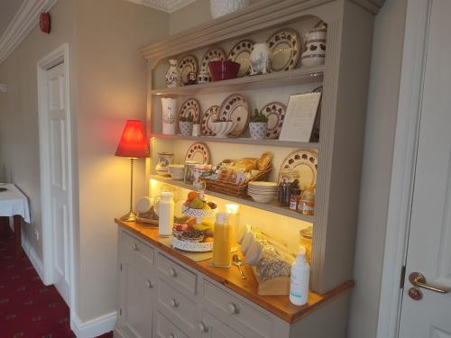a kitchen with a hutch filled with food and dishes at Shannonside House N37HF67 in Athlone