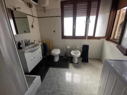 a bathroom with a sink and a toilet and a sink at Well in Filettole