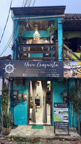 a blue building with a sign in front of it at Nova Conquista in Paraty