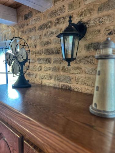 a lamp and a lighthouse on a wooden table at Gite du lac du Palentin Ardres in Ardres