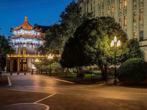 a building with a pagoda in a park at night at Sofitel Legend People's Grand Hotel Xi'an in Xi'an