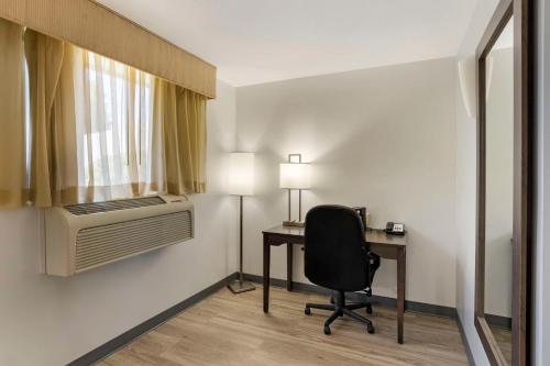 a room with a desk and a chair and a window at Best Western DuBois Hotel in DuBois