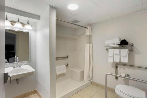 a bathroom with a toilet and a sink and a shower at Best Western DuBois Hotel in DuBois