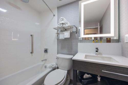 a white bathroom with a toilet and a sink at Best Western PLUS Downtown/Music Row in Nashville