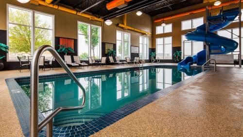 a swimming pool with a slide in a building at Best Western Blairmore in Saskatoon