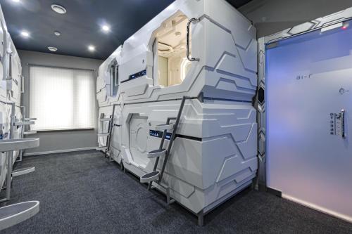 a room with a bathroom with a washing machine at CAPS LOCK Future Hotel in Astana