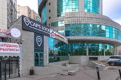 a large building with a sign in front of it at CAPS LOCK Future Hotel in Astana