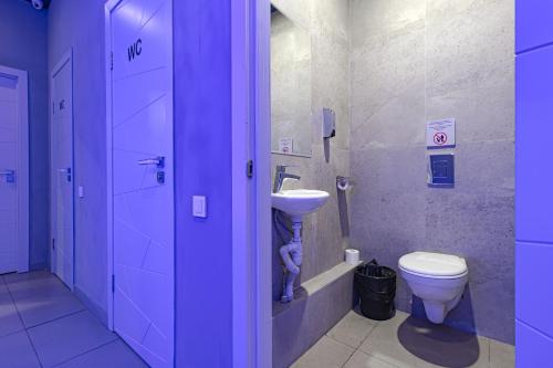 a bathroom with a toilet and a sink at CAPS LOCK Future Hotel in Astana