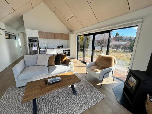 a living room with a couch and a coffee table at Tekapo Toi Toi in Lake Tekapo