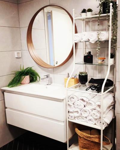 a bathroom with a sink and a mirror at Sweet Sea Side Eilat - סוויט סי סייד, אילת in Eilat