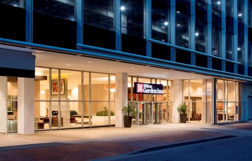 a building with a sign on the front of it at Hilton Garden Inn Downtown Dallas in Dallas