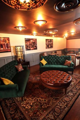 a living room with green couches and a rug at Hilton Garden Inn Downtown Dallas in Dallas