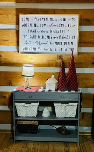 a table with a lamp and a sign on a wall at Lodge at Bradley Mtn in Townsend