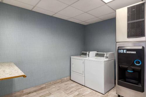 a laundry room with a washer and dryer and a refrigerator at Wingate by Wyndham Savannah I-95 North in Port Wentworth
