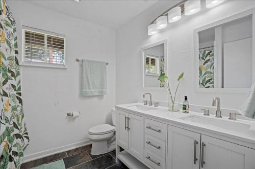 a white bathroom with a toilet and a sink at Small Town, Big House - Sleeps 8! in Taylor